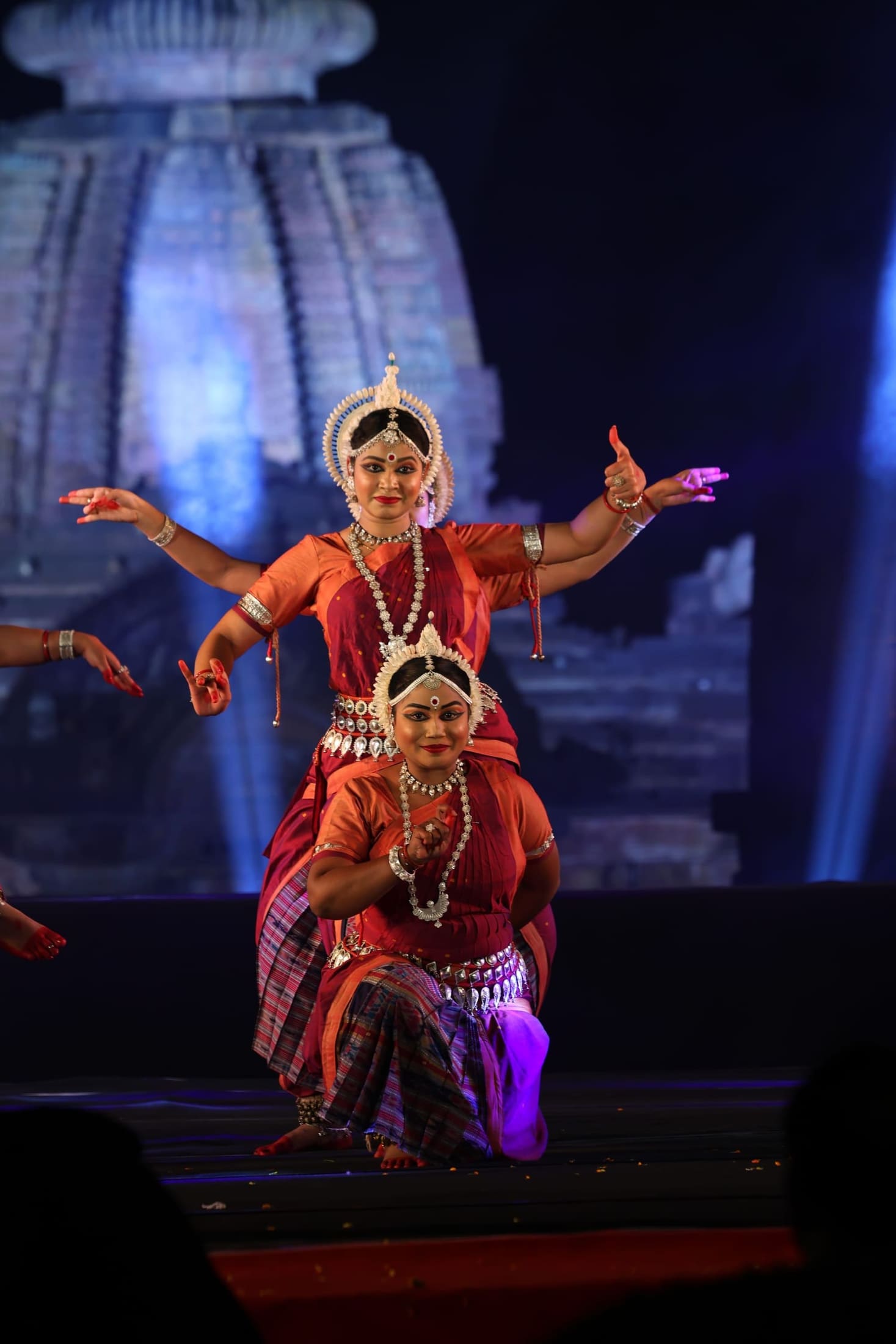 Odissi duet dancers mid-movement on festival stage
