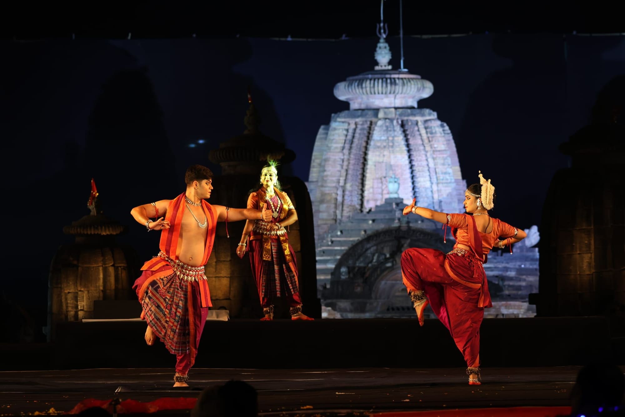 Dynamic mixed ensemble performance with male dancer on festival stage