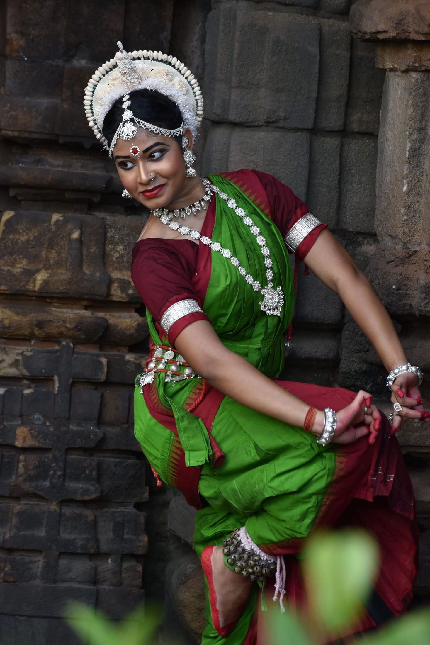 Truptismita Tarini, Founder & Mentor, standing solo in a temple alcove