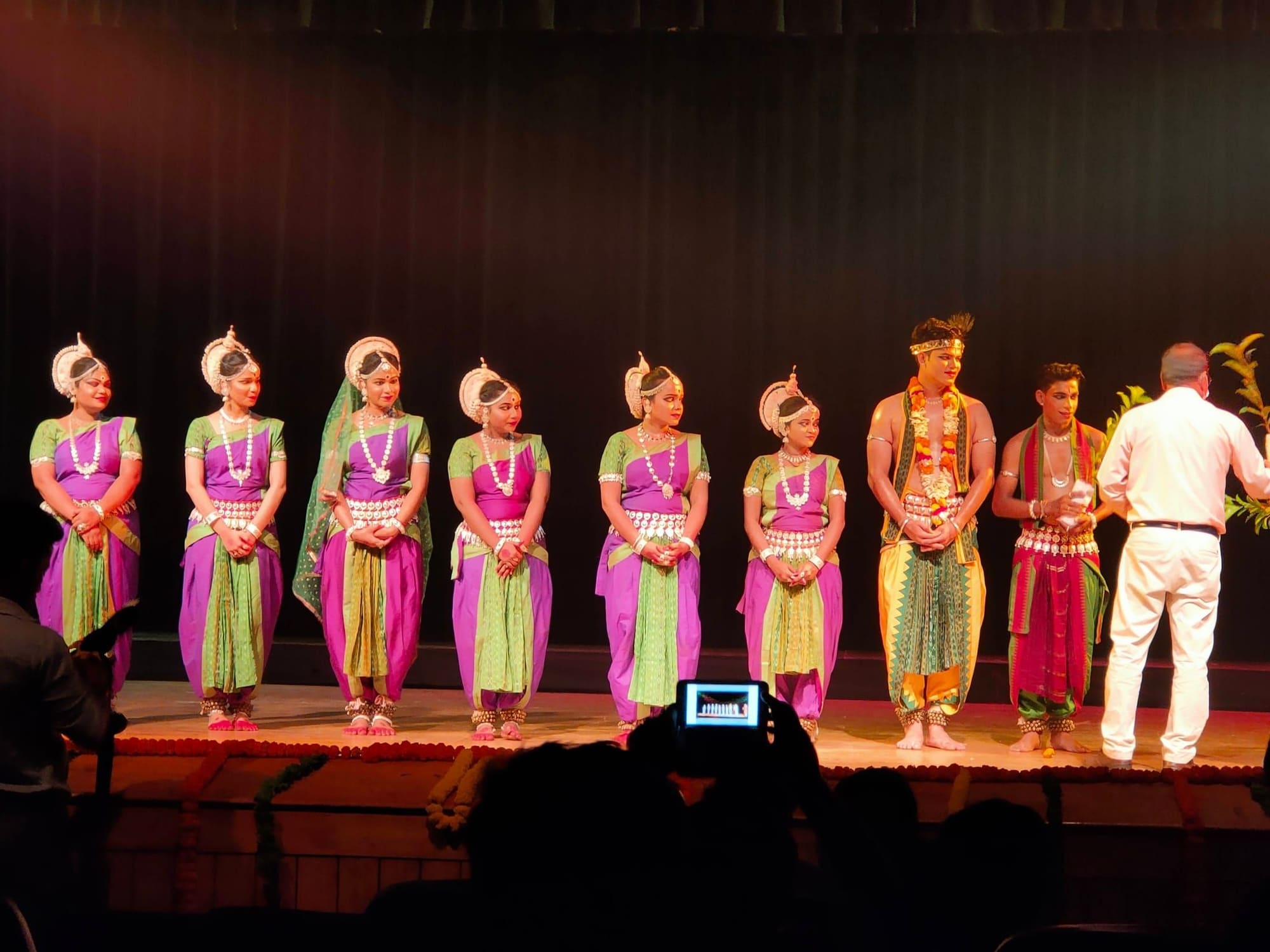 Ensemble curtain call in purple and green costumes, 2021