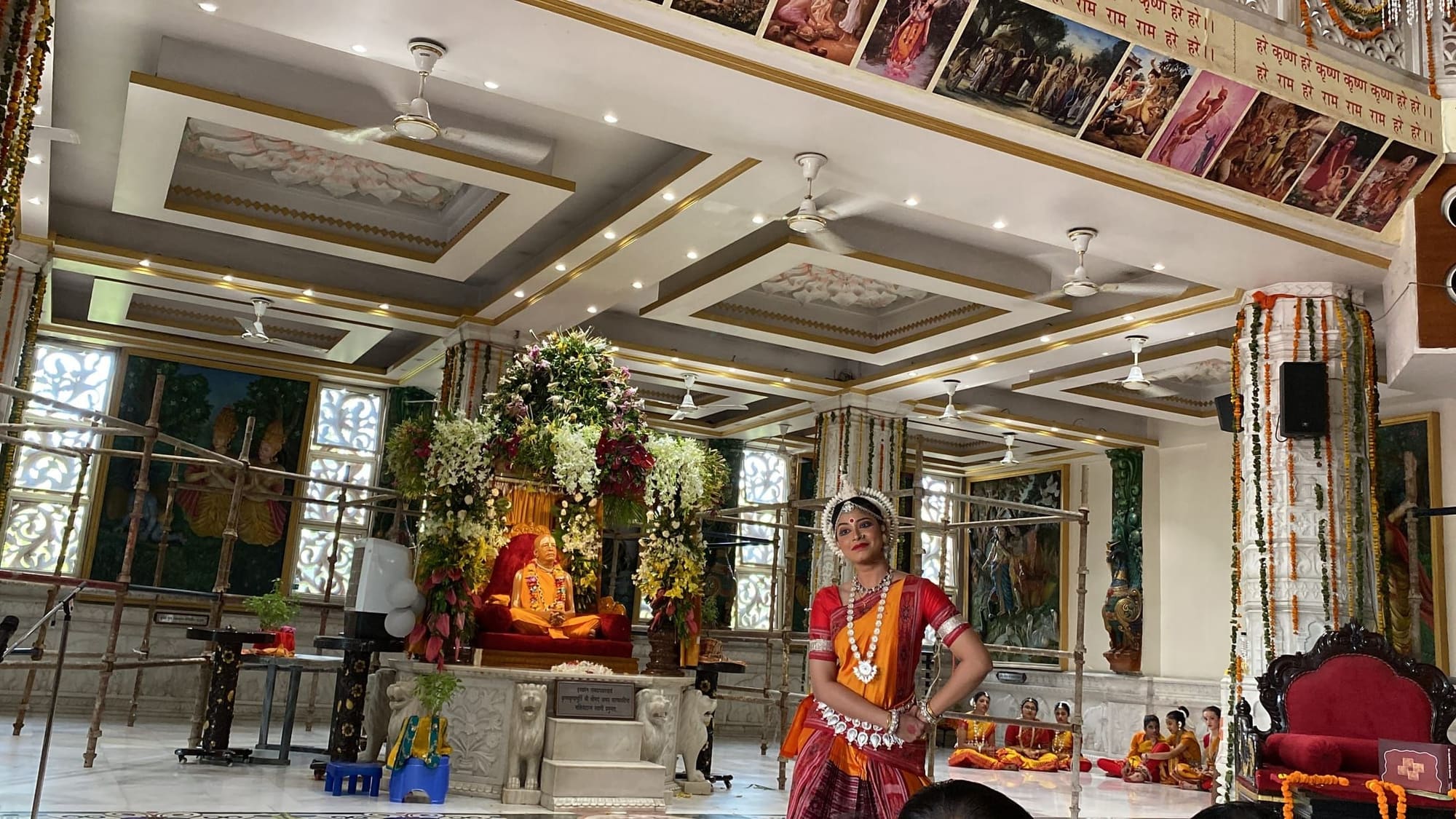 Odissi dancer performing solo inside a temple hall before the guru murti