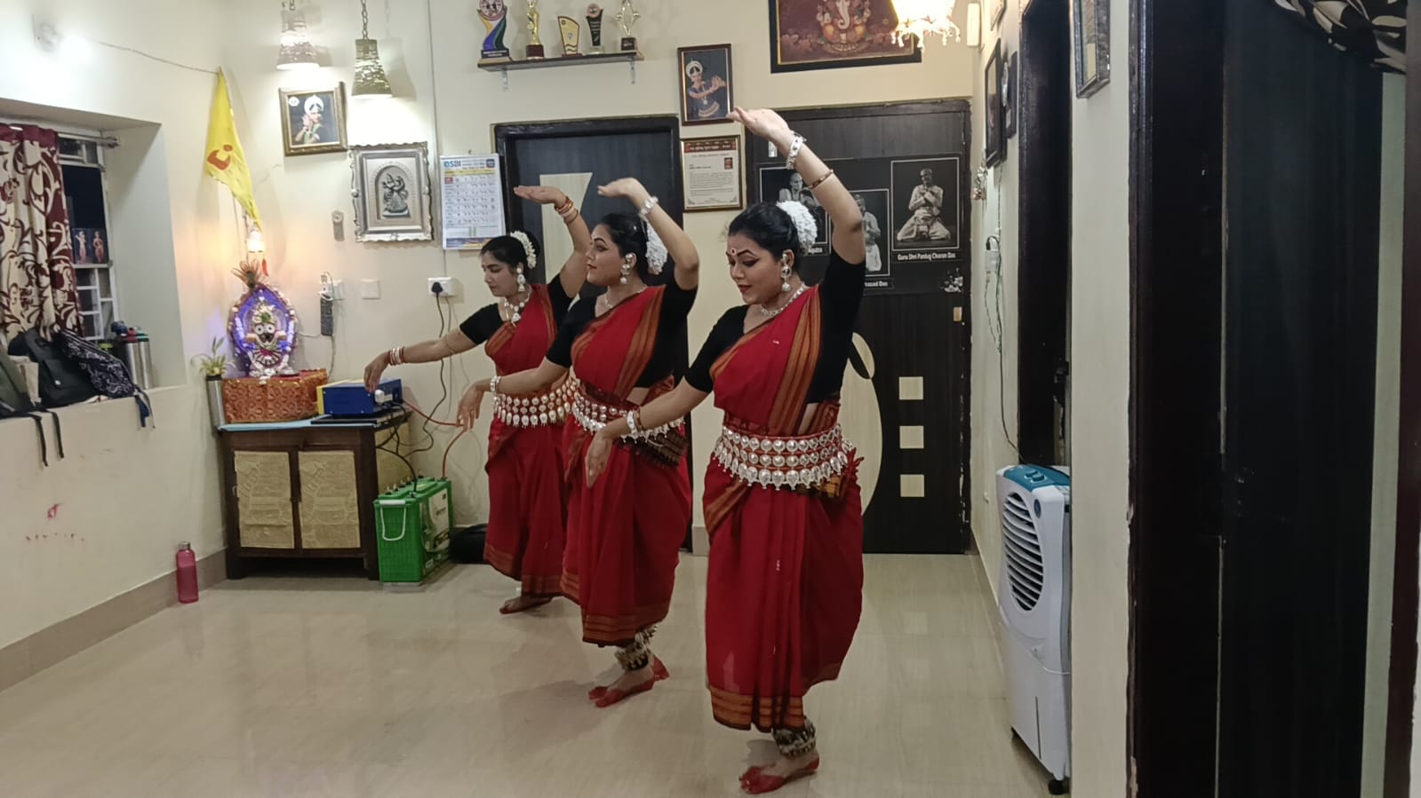 Summer class dancers rehearsing an Odissi pose in red costume