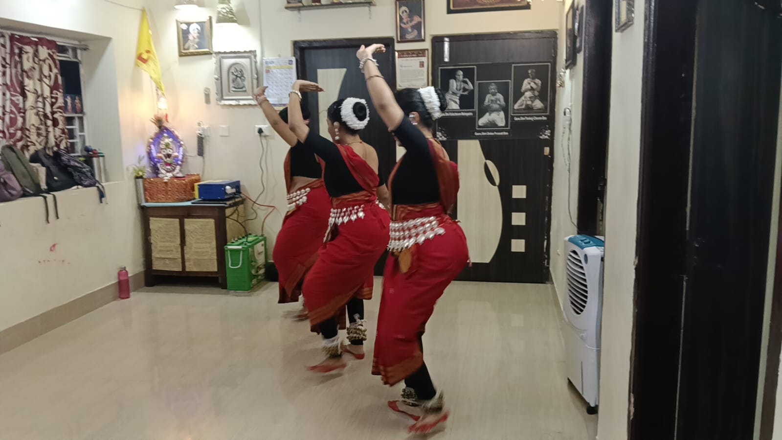 Summer class dancers mid-movement in a dynamic Odissi chauka