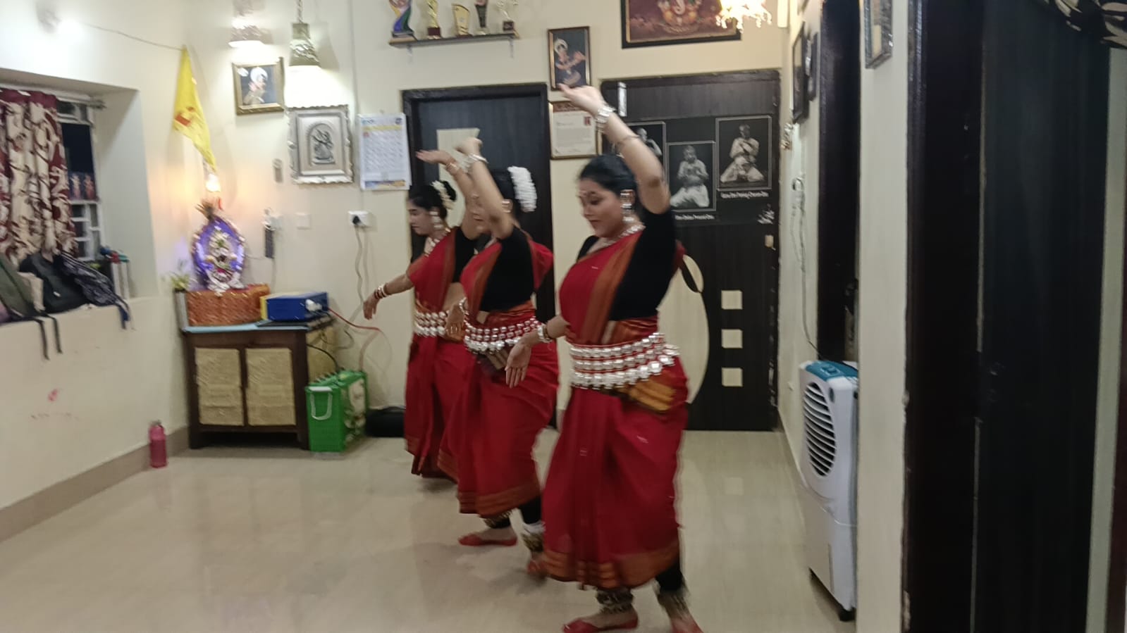 Summer class dancers holding a graceful raised-arm formation
