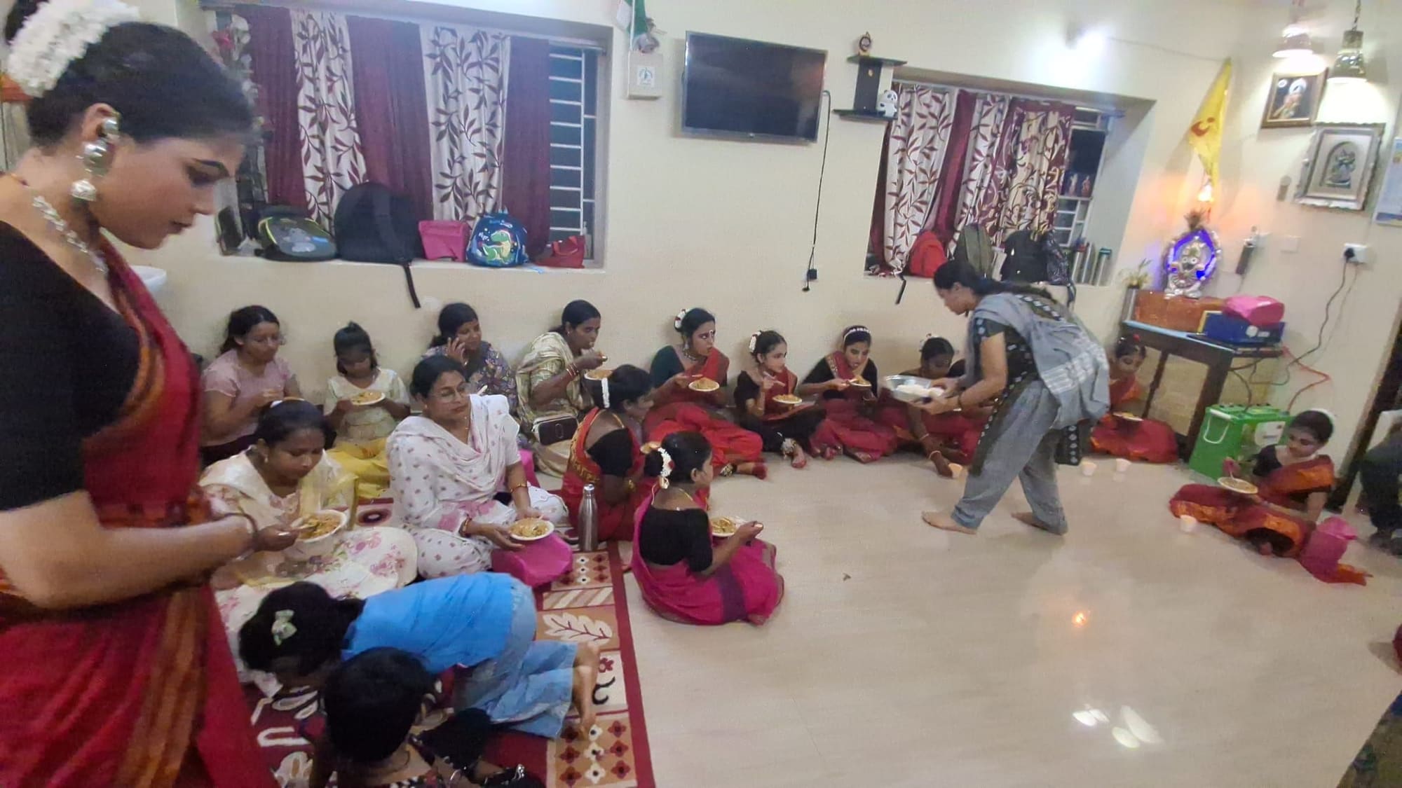 Summer class students and teachers sharing a meal together in the studio