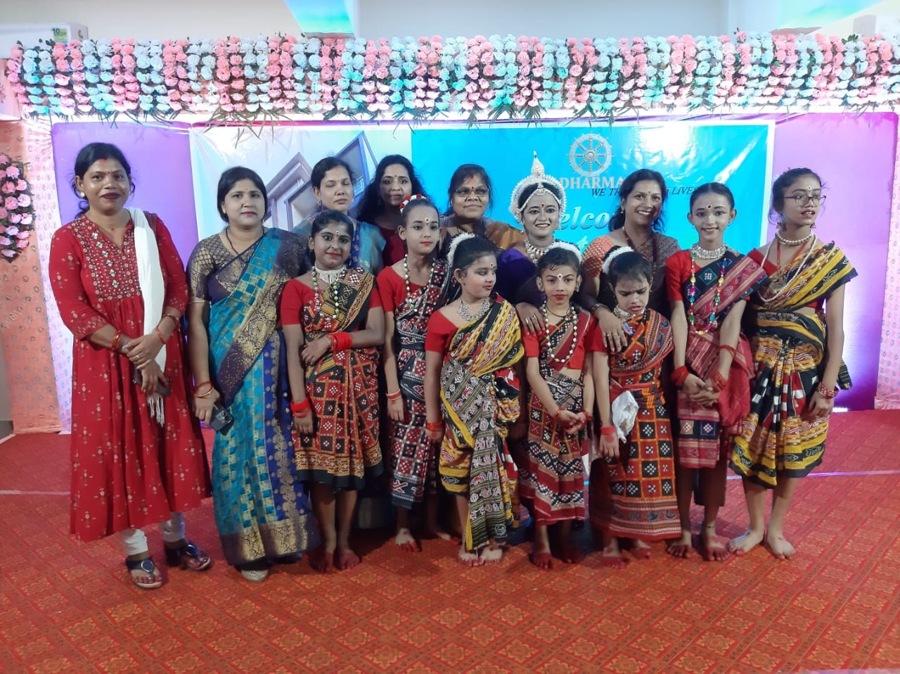 Students and teachers with certificates and trophies at a welcome event