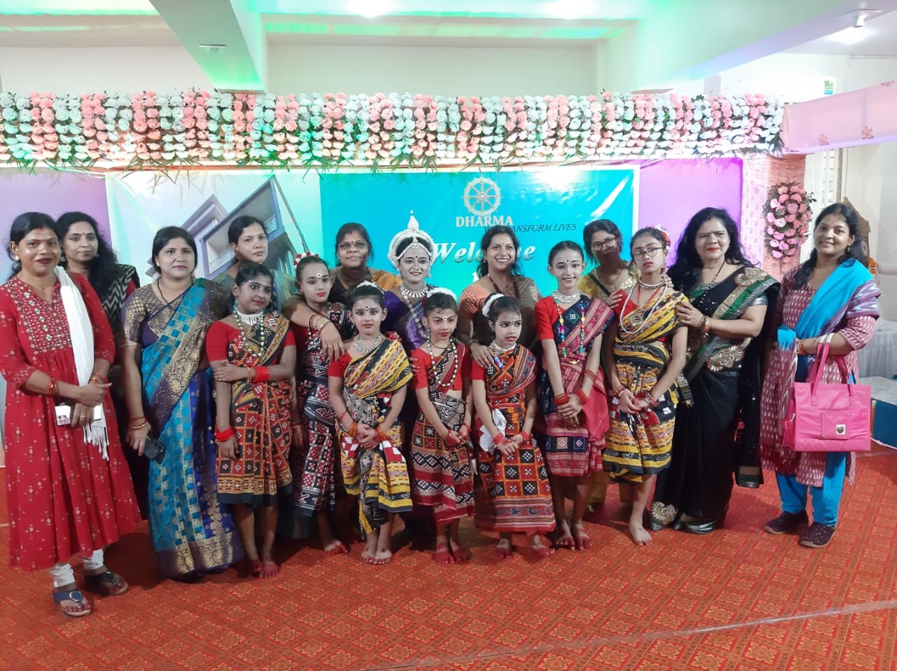 Larger group photo of students and teachers at a welcome event